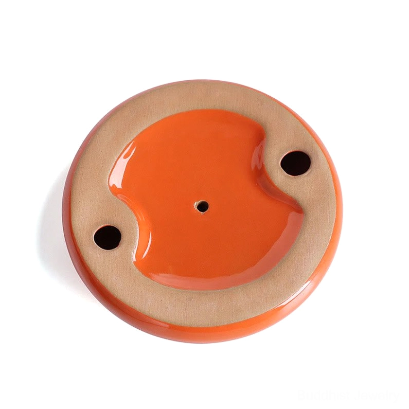 Persimmon ceramic incense burner in meditation altar setup with candles and spiritual objects creating peaceful contemplation space