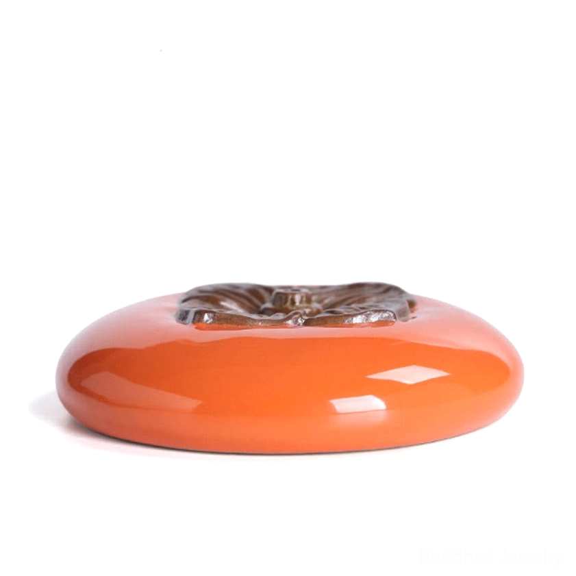 Buddhist incense holder persimmon ceramic design with cultural significance displayed in yoga studio or wellness center environment