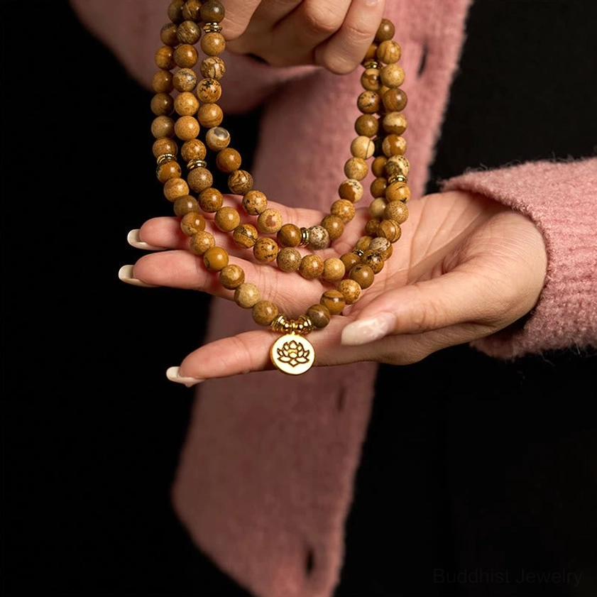 Picture jasper 108 bead mala bracelet with white lotus charm pendant worn on wrist