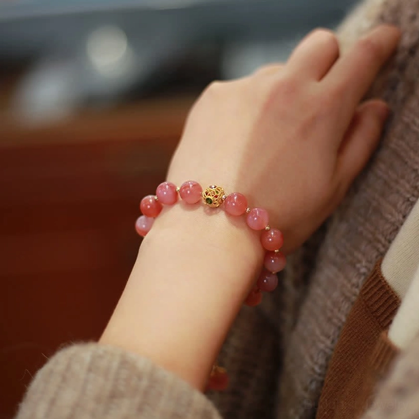 Pink Yanyuan agate bracelet worn on wrist showing smooth round beads and natural color