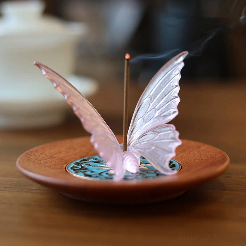 Pink Liuli glass butterfly incense burner on wooden tea table with burning incense and enamel tray