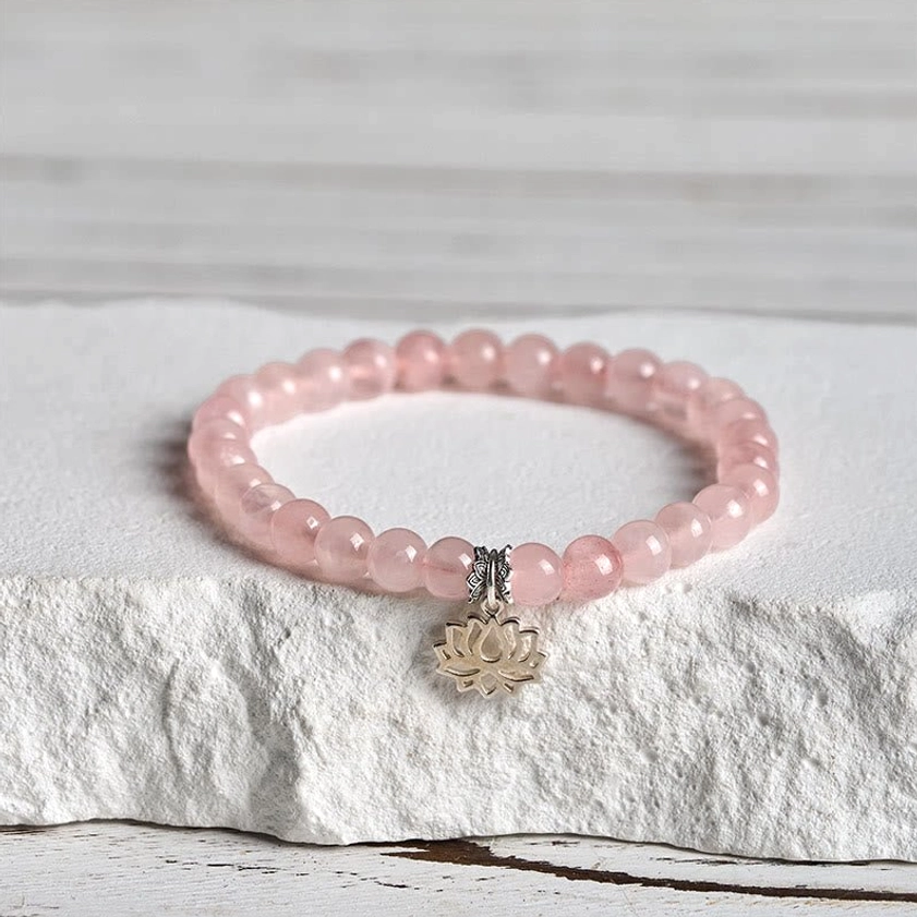 Pink crystal lotus bracelet with smaller 6mm beads and sterling silver charm close-up detail shot