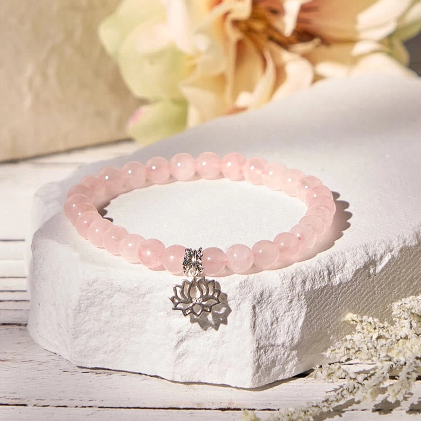Pink crystal lotus charm bracelet worn on wrist showing comfortable fit and daily wear appeal