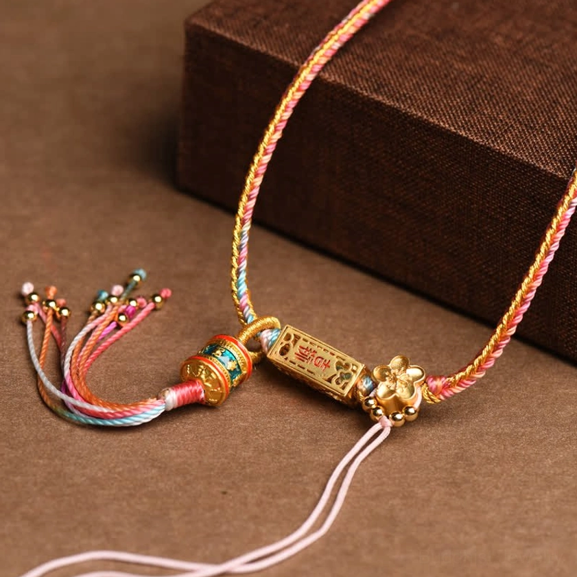 Pink and gold braided copper Buddhist necklace pendant with flower-shaped enamel hardware and engraved charm detail