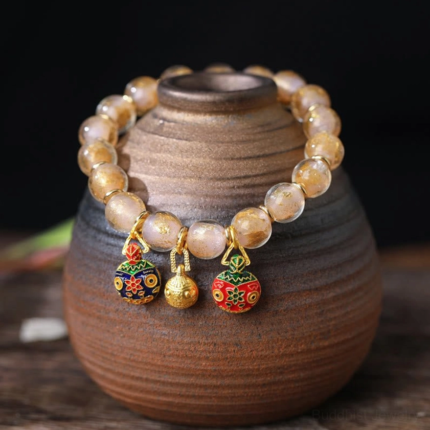 Pink gold Liuli glass bead bracelet featuring rose-toned beads with gold-plated Pixiu wealth guardian charms - compassion and healing Buddhist bracelet