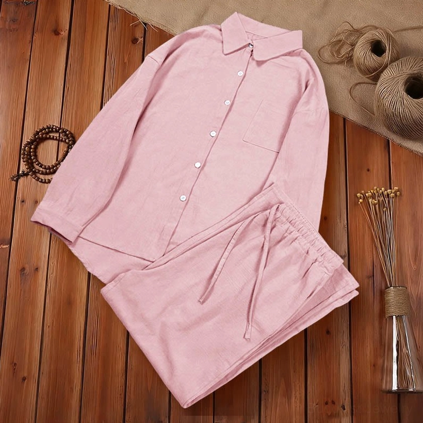 Pink cotton meditation set flat lay on wooden table with zen lifestyle props