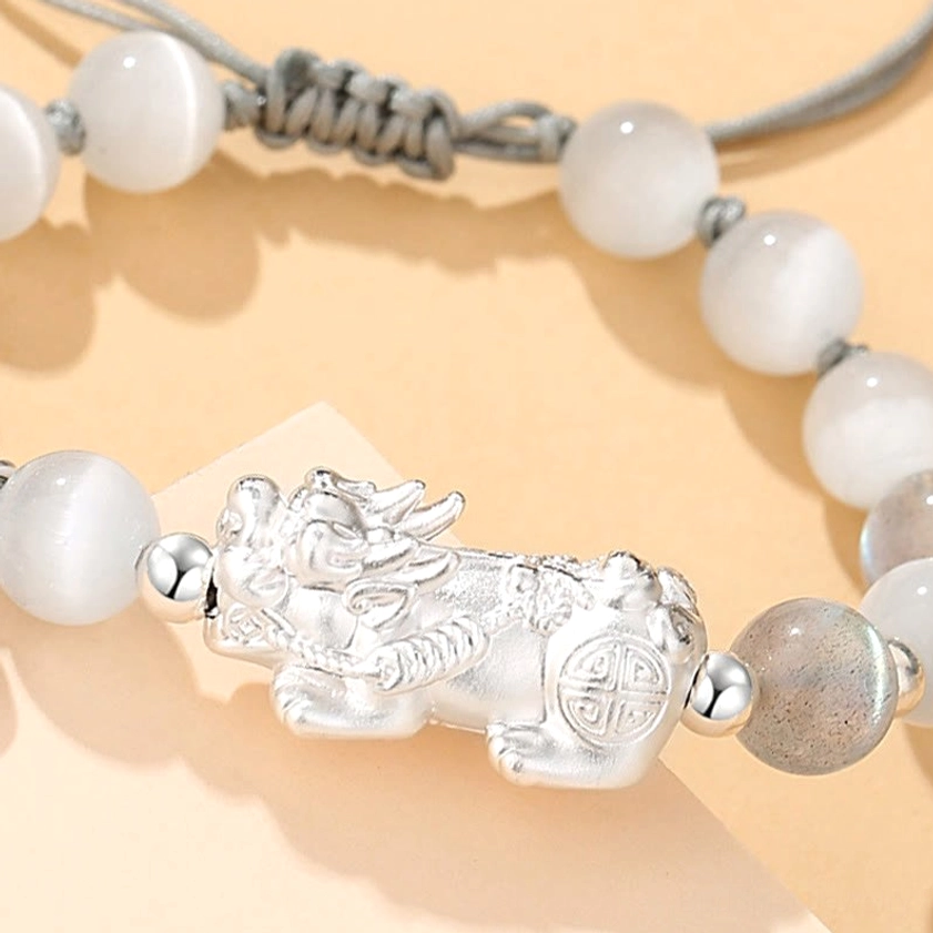 Adjustable braided cord mechanism on Pixiu Buddhist prosperity bracelet, functional design detail