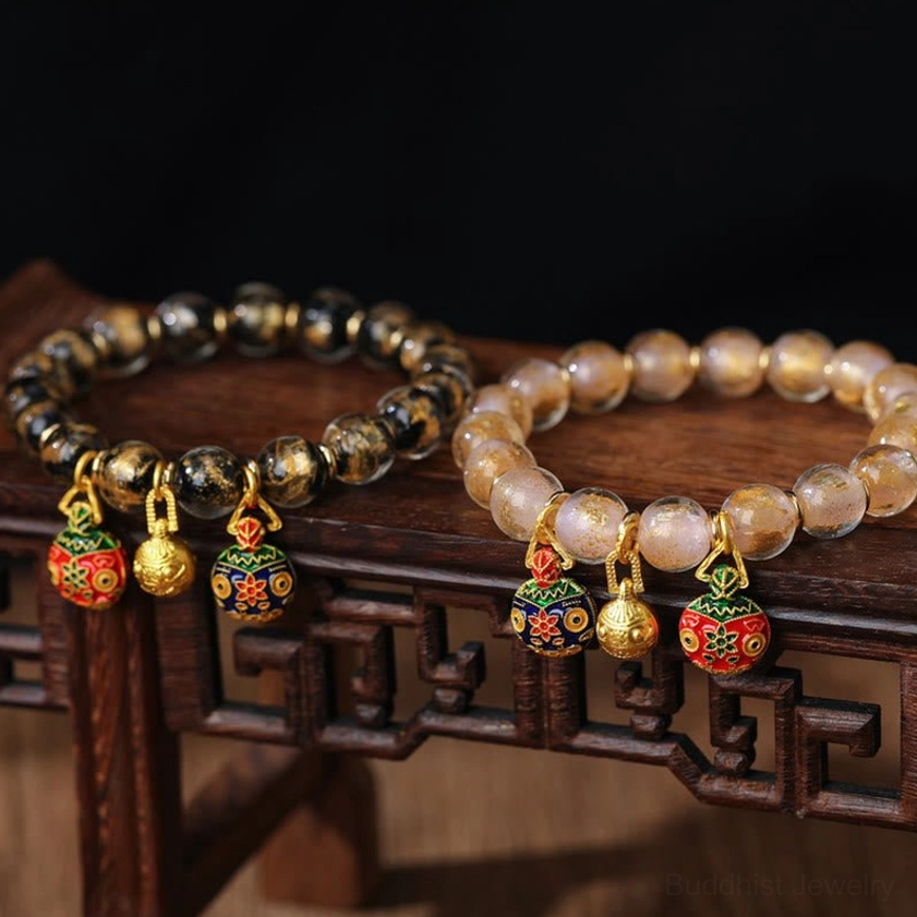Multiple assorted Pixiu prosperity bracelets with light and dark Liuli glass bead strands on wooden traditional display rack - Buddhist fortune charm bracelet collection