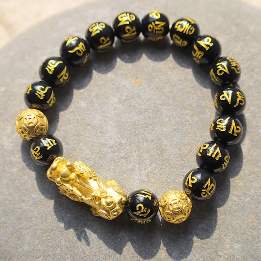 Pixiu wealth bracelet layered with other bracelets showing versatile styling and unisex design for all wearers