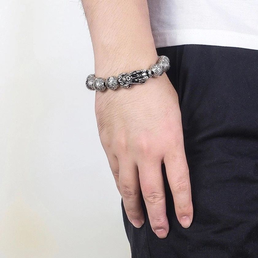 Buddhist Pixiu bracelet worn on left wrist casual lifestyle photo, antique silver beaded bracelet with protective guardian charm for abundance