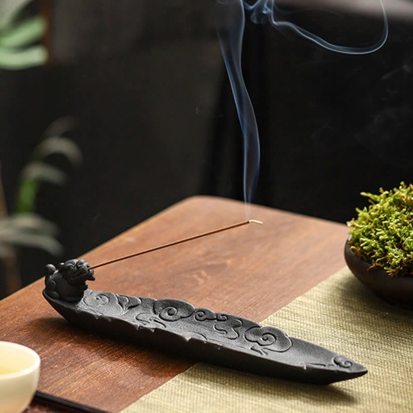 Pixiu auspicious clouds ceramic incense burner on tea table with rising smoke and moss decor