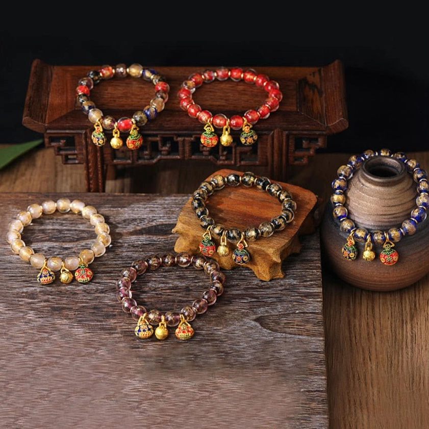 Close-up detail of Pixiu family prosperity charm and luminous Liuli glass beads showing craftsmanship - handmade Buddhist fortune protection bracelet texture