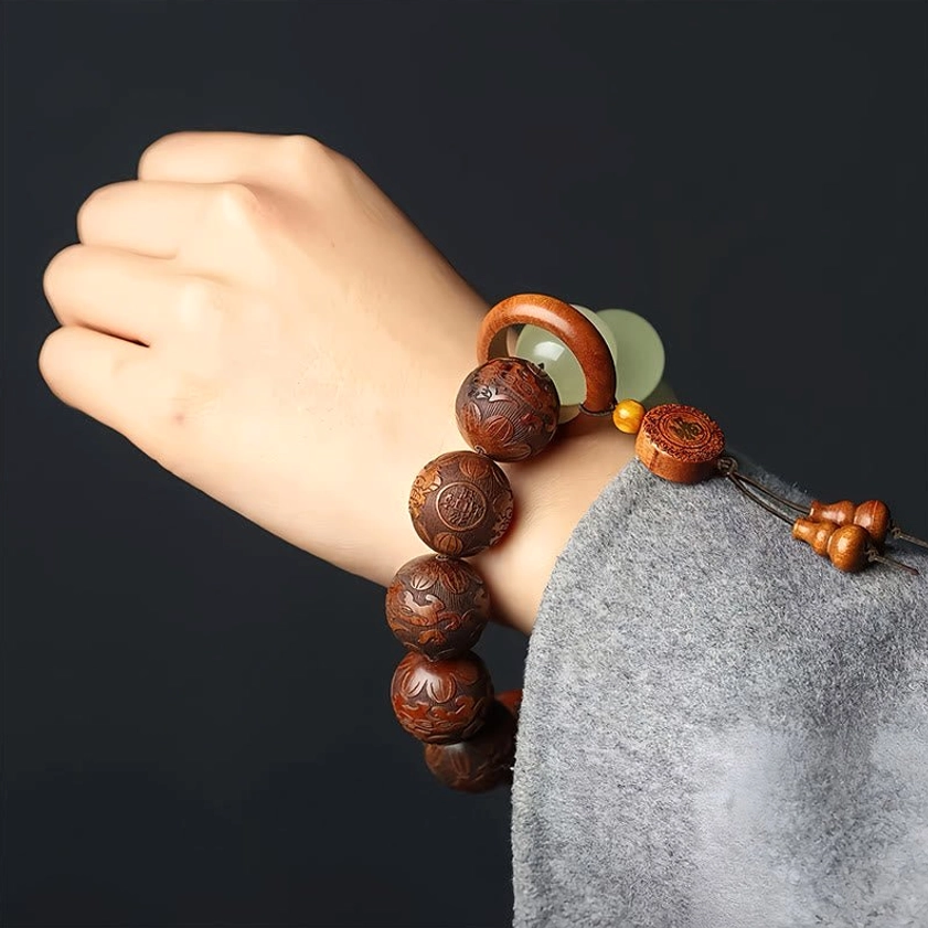 Buddhist Pixiu Fu bracelet worn on wrist with grey sweater, showing comfort fit and wooden bead details