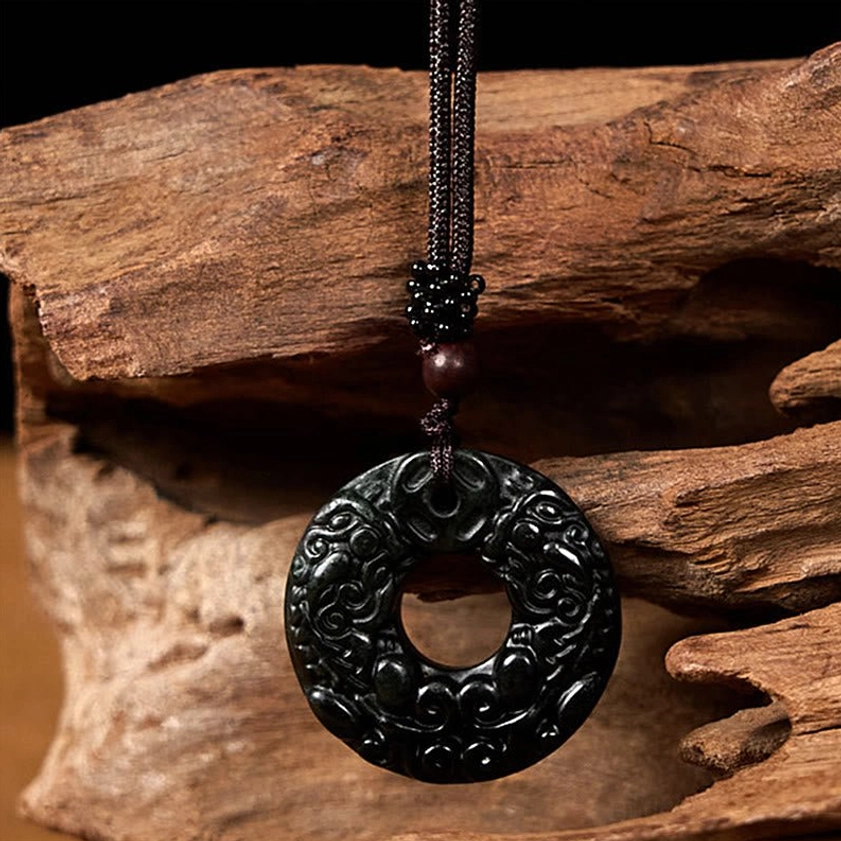 Jade Pixiu peace buckle pendant with carved guardian design and brown beaded accent cord detail