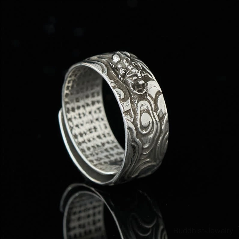 All-silver Pixiu Heart Sutra Buddhist ring side profile with embossed cloud patterns and no gold accents, reflecting light on dark background