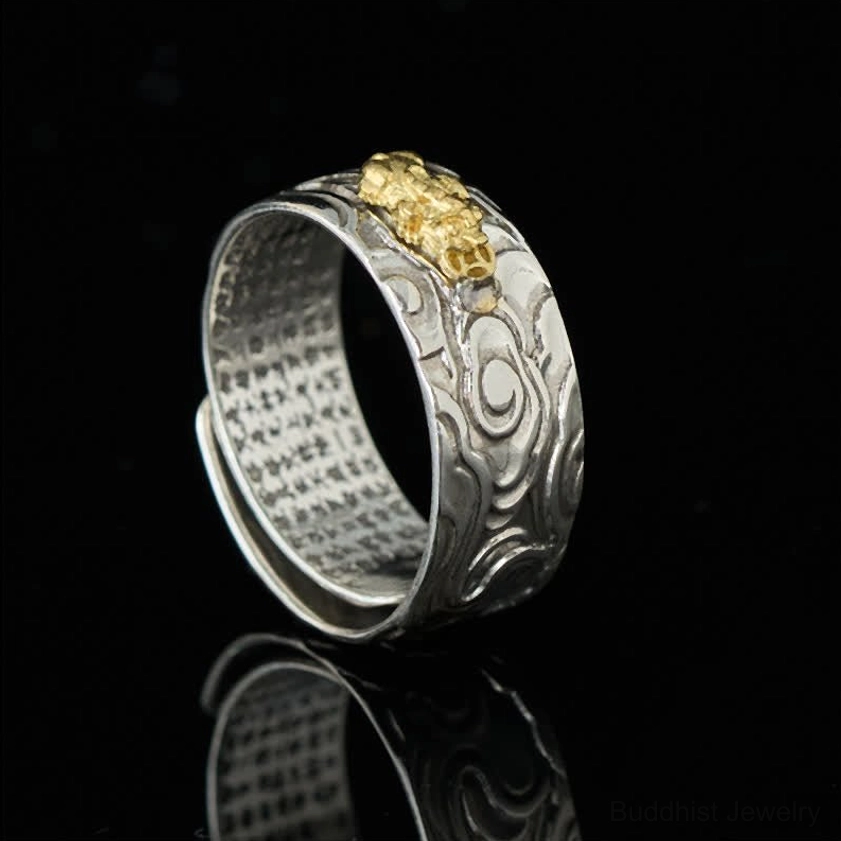 Buddhist Pixiu prosperity ring from 3/4 side angle, featuring gold Pixiu guardian ornament on silver band with reflective studio finish