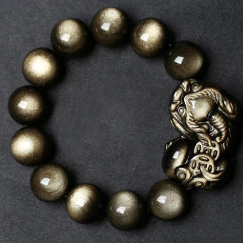 Complete golden obsidian Pixiu bracelet flat lay overhead view on gray background showing full bead arrangement