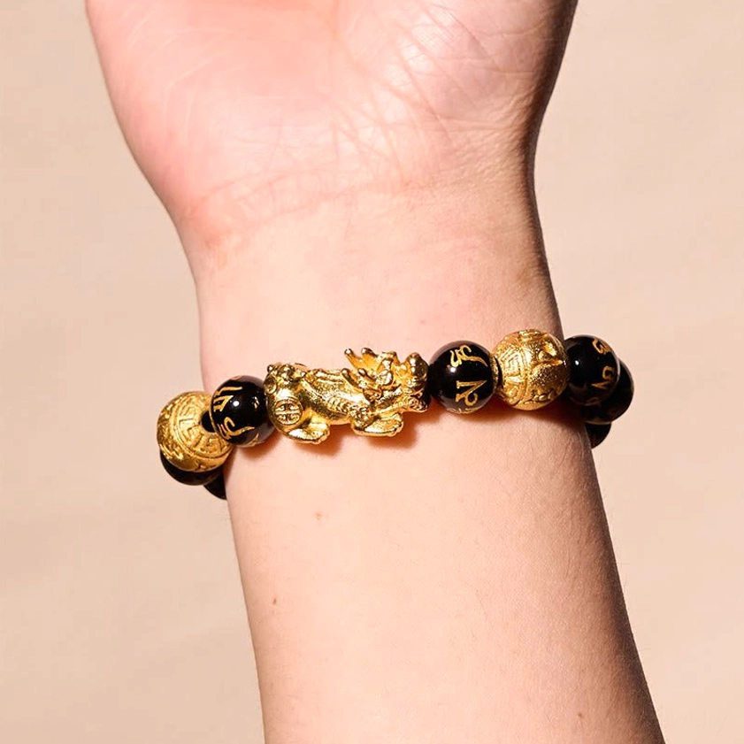 Worn obsidian PiXiu wealth bracelet on wrist showing compact bead sizing and proper fit for daily wear
