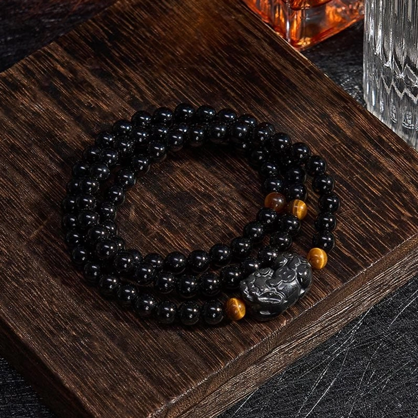 Pixiu obsidian wealth bracelet with rainbow obsidian beads showing iridescent and protective crystal combination
