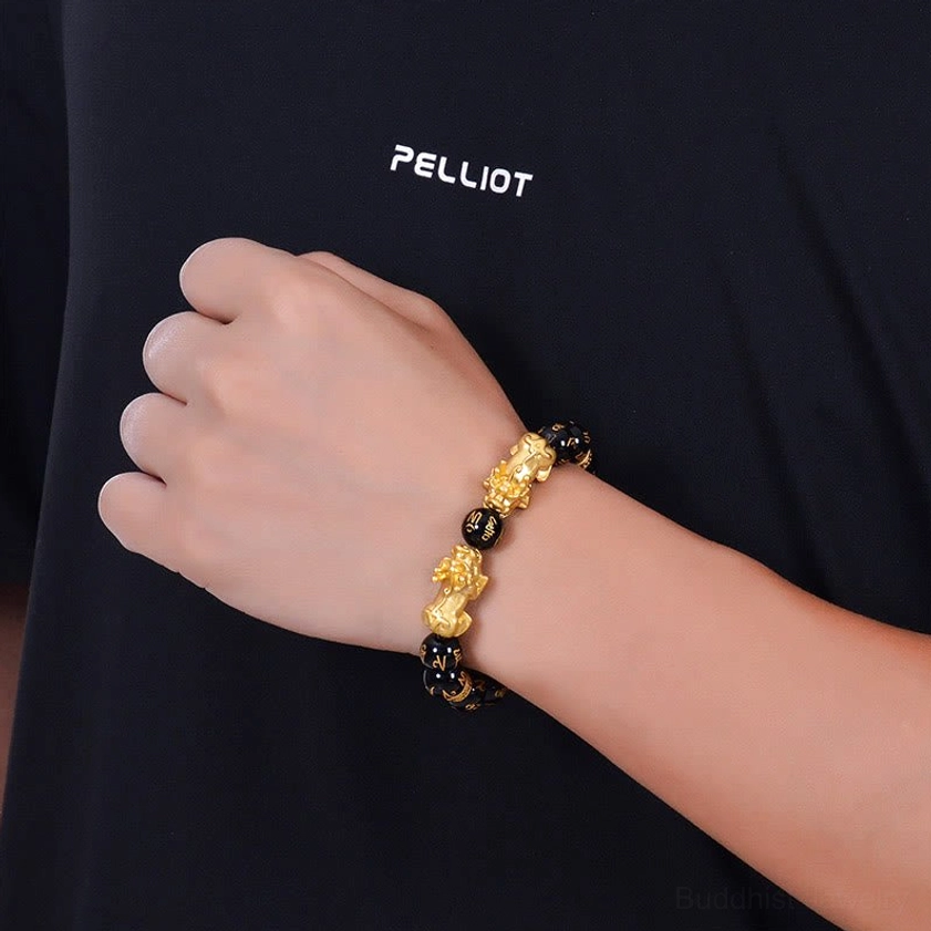Buddhist Pixiu protection bracelet worn on wrist showing slim fit and black gold color scheme