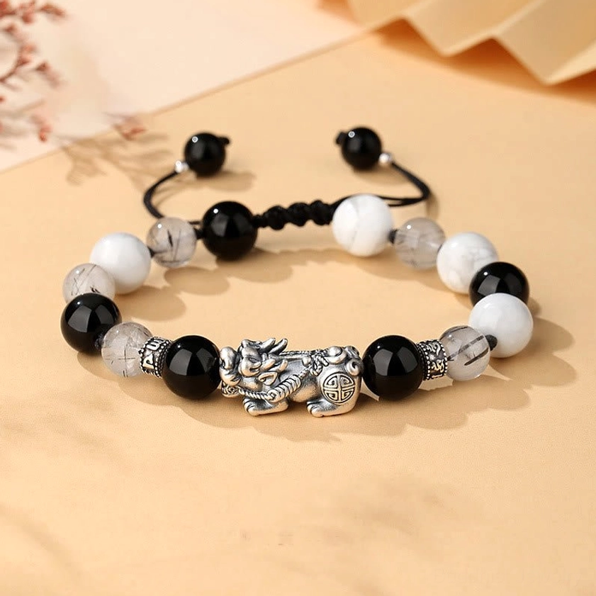 Pixiu prosperity bracelet with Om Mani Padme Hum mantra, 999 sterling silver charm with black obsidian and white turquoise beads, top-down view