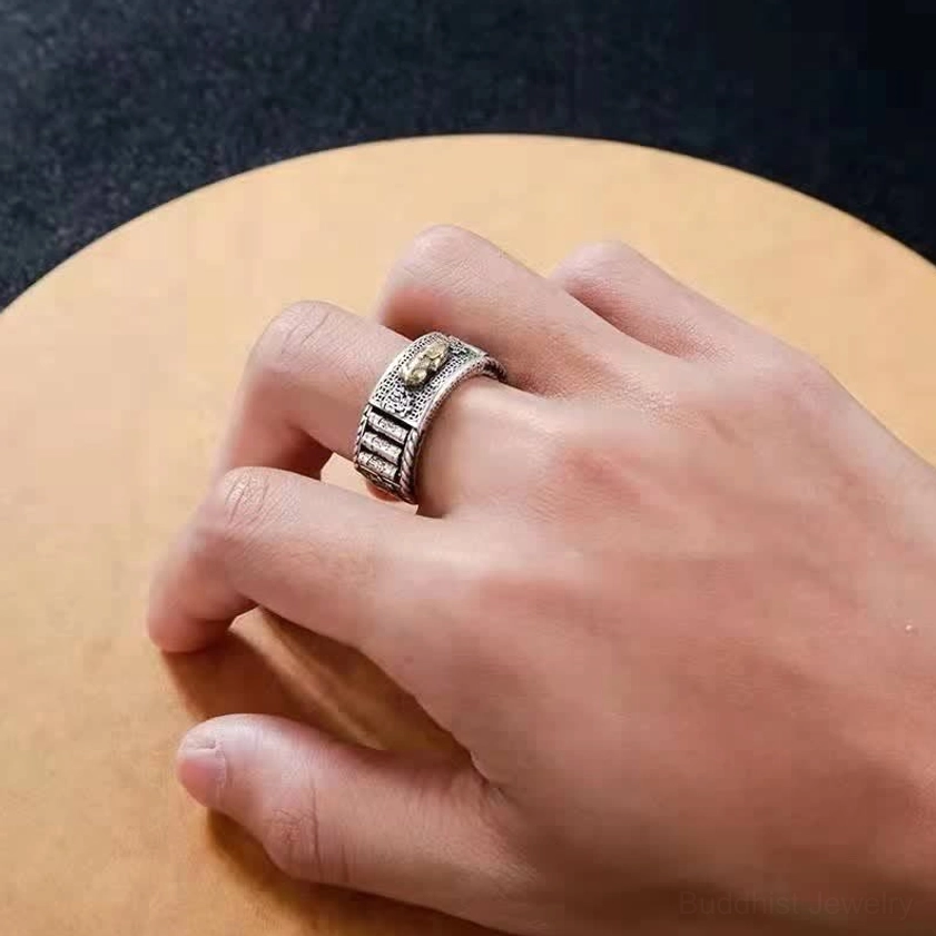 Pixiu wealth ring in silver tone with gold accents - hand-wear side close-up on wooden background highlighting retro carved texture and open adjustable design