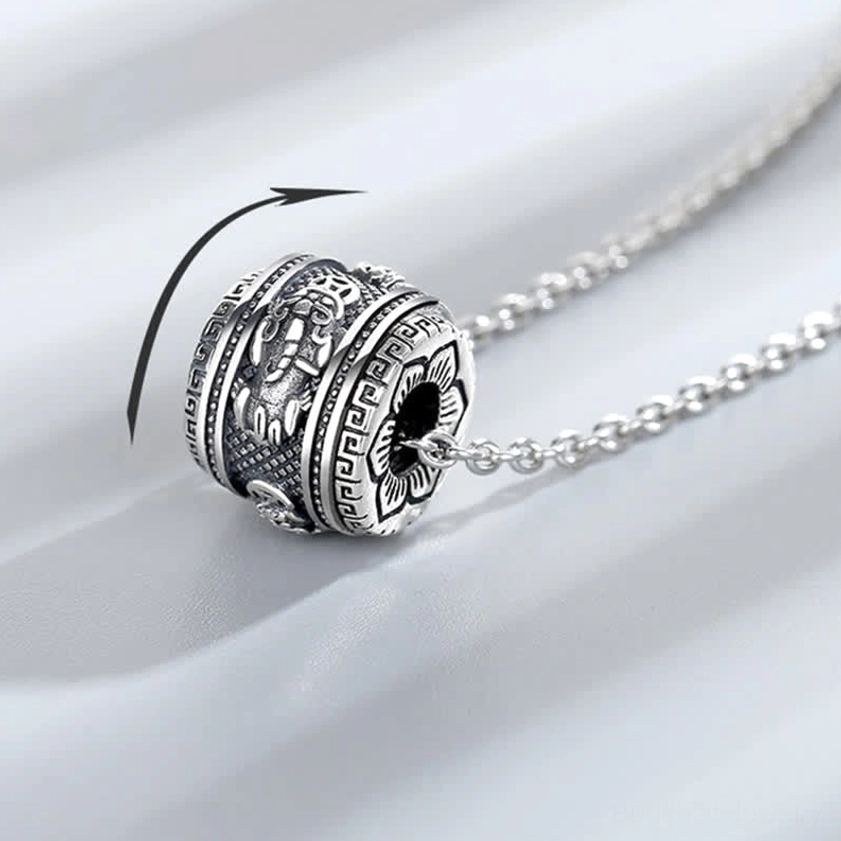 Pixiu rotating necklace pendant side view demonstrating rotatable function with vintage embossed Buddhist patterns and carving