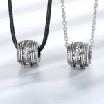 Pixiu rotating wealth necklace pendant with optional chains - flat lay studio view showing vintage silver carved details and dual chain styles