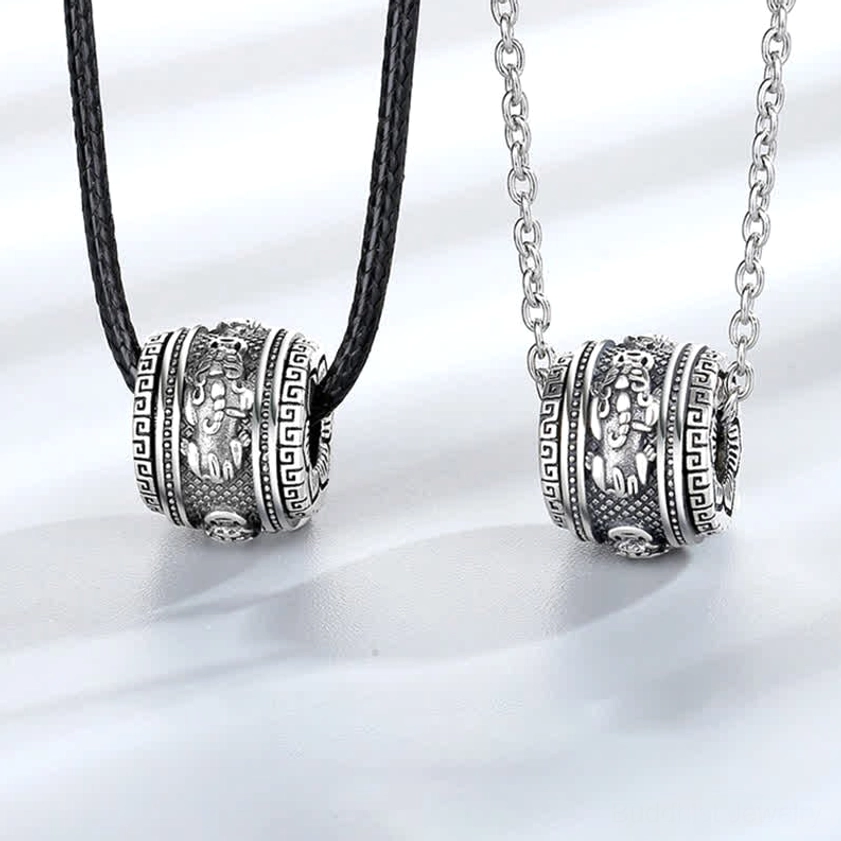 Pixiu rotating wealth necklace pendant with optional chains - flat lay studio view showing vintage silver carved details and dual chain styles