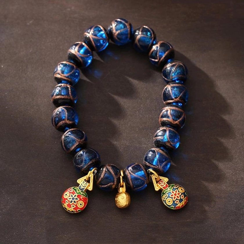 Complete gold pixiu fortune bracelet with blue liuli glass beads and matching protective charms