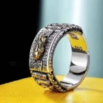 Pixiu wealth prayer wheel ring in gold finish - side overhead close-up view showcasing S925 sterling silver stamp and vintage carved Buddhist prosperity symbol design