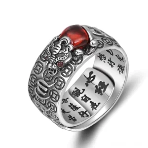 Pixiu feng shui wealth ring with red garnet stone and engraved Heart Sutra, vintage silver copper finish, close-up top view