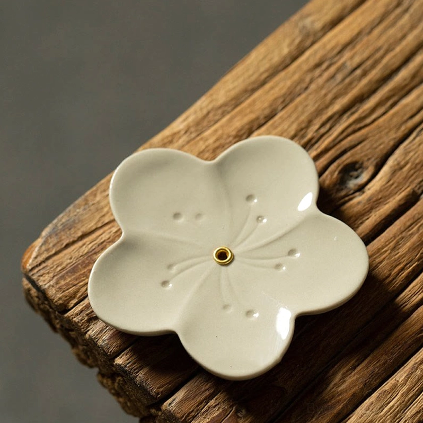 Plum blossom style ceramic incense holder with engraved dot patterns on petals