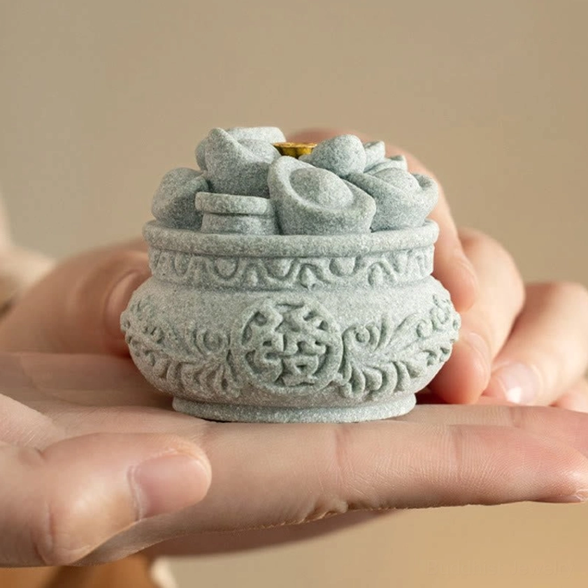 Compact portable Buddhist incense burner held in palm showing portable size for travel