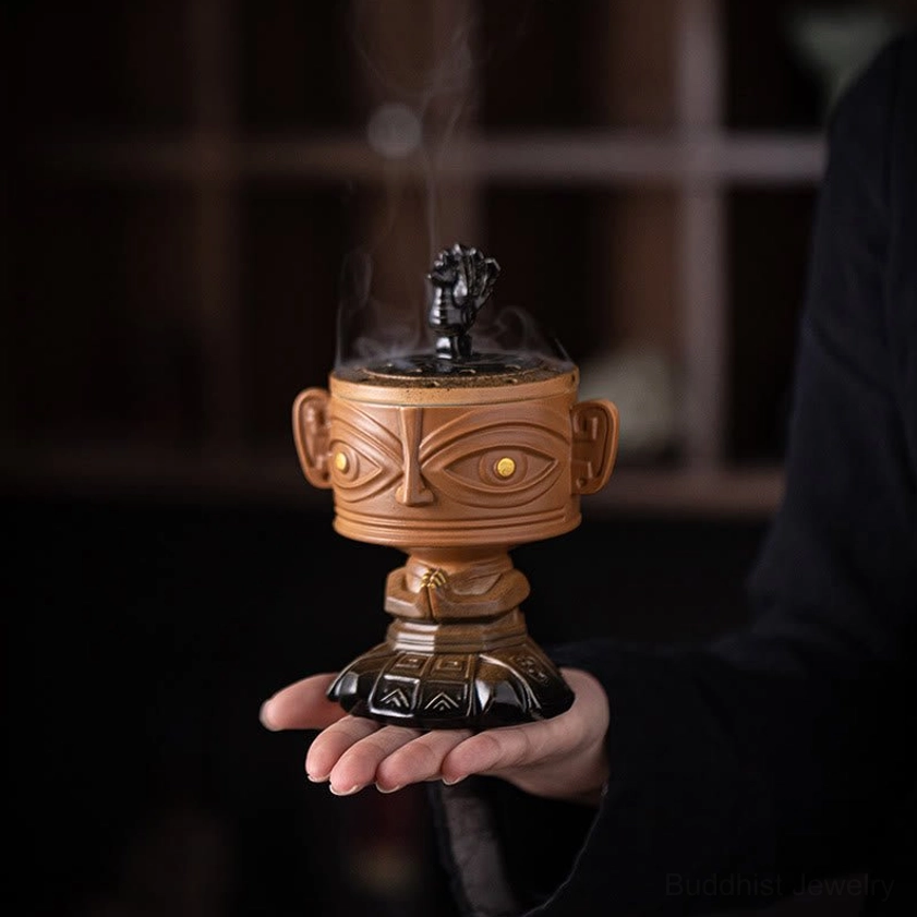 Ceramic incense holder with smoking incense held in palm, demonstrating compact portable size