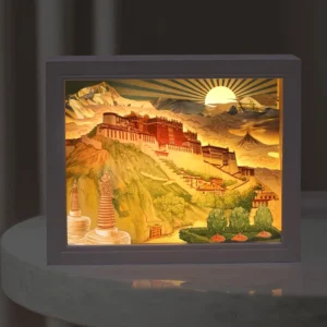 Potala Palace paper carving LED lamp illuminated on desktop with warm soft light and dark photo frame