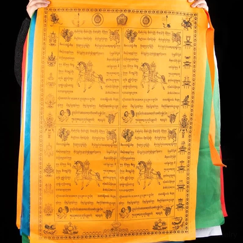 Orange Buddhist prayer flag side view displaying full Tibetan mantras and colorful ribbon trim