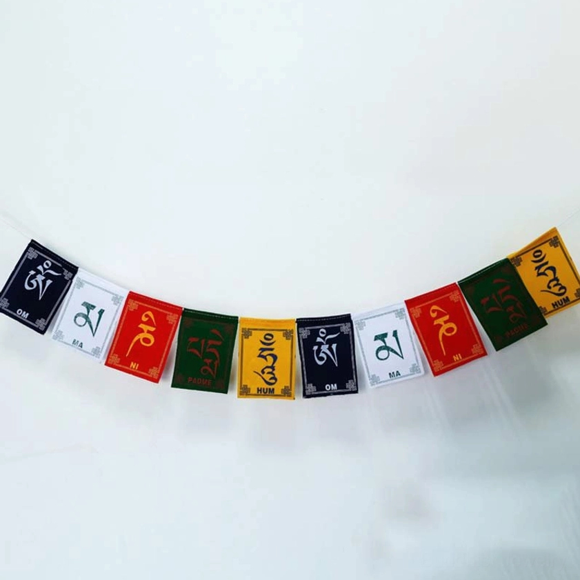 Straight strand of traditional Buddhist prayer flags featuring five sacred colors and Om Mani Padme Hum