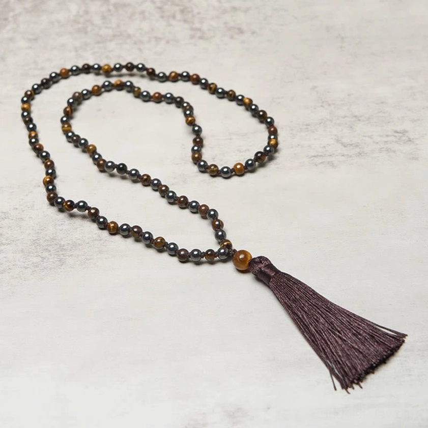 Full 108 bead mala prayer necklace extended flat lay showing complete strand and tassel