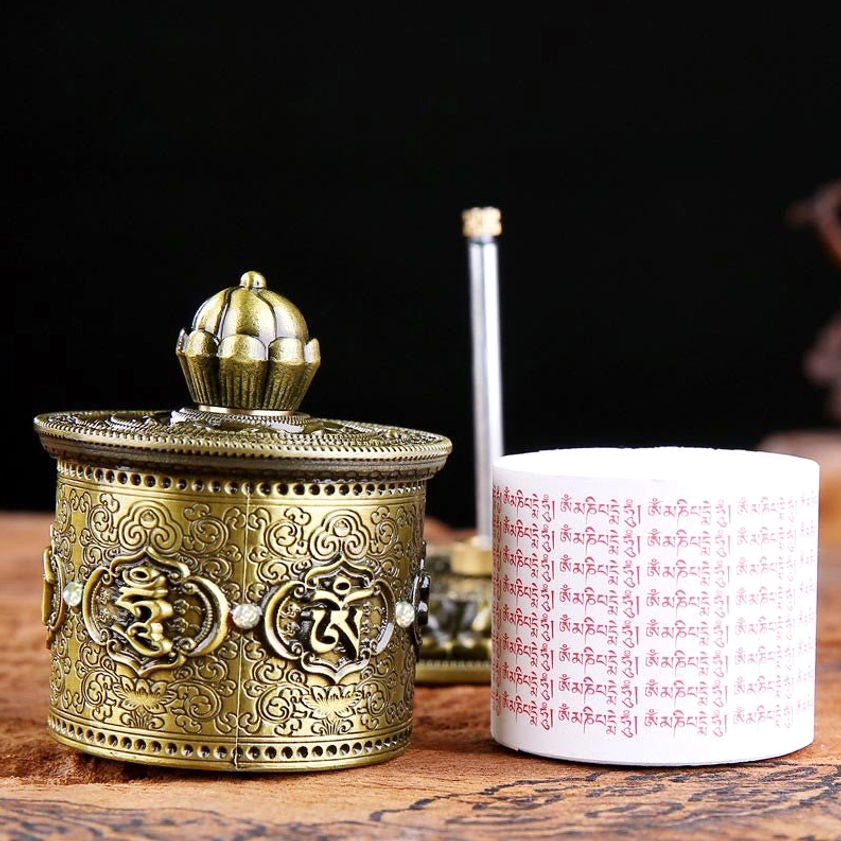 Complete Buddhist prayer wheel set showing detachable cylinder with white scripture roll and base foundation