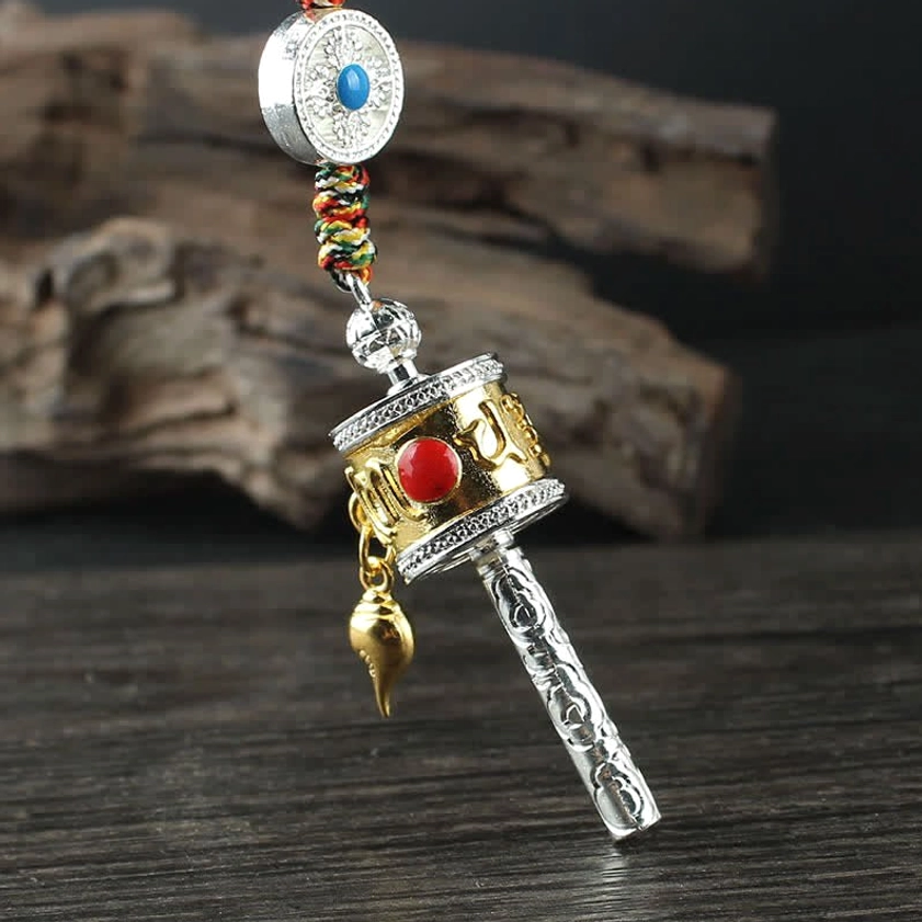 Buddhist prayer wheel car hanging with gold-silver color, blue gemstone round plate, red inlaid stone, and carved handle with drop pendant