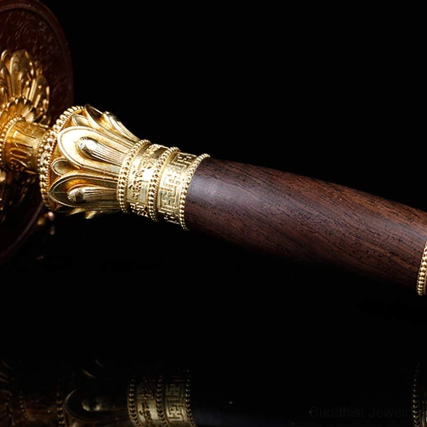 Prayer wheel handle section with wooden grip, carved gold lotus trim, and engraved metal bands detail