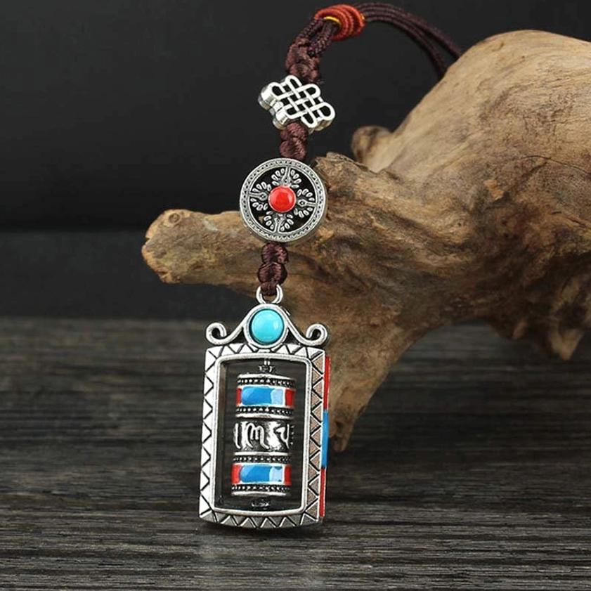 Buddhist prayer wheel keychain with turquoise bead and traditional Chinese knot detail in vertical view