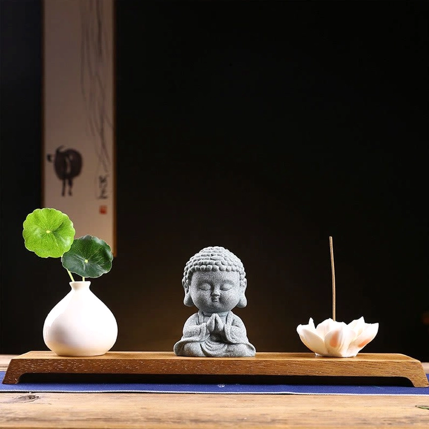 Praying Buddha statue with wooden base and vase elegant meditation altar centerpiece for spiritual sanctuary