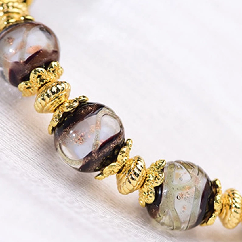 Premium nine-eye dzi bead bracelet with incense ash liuli glass and gold-toned metal accents