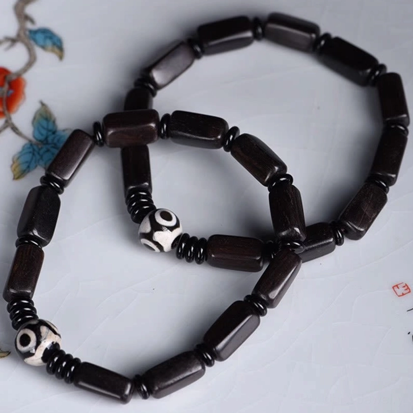 Premium ebony wood beads with hand-crafted two-eye Dzi bead bracelet featuring black spacer elements