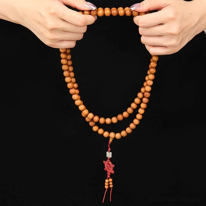 Premium red sandalwood meditation mala beads with natural grain and color variation