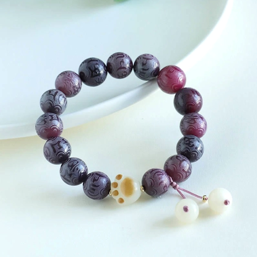 Purple Bodhi Seed Om Mani Padme Hum bracelet with white tassel pendants and paw-print jade charm accent