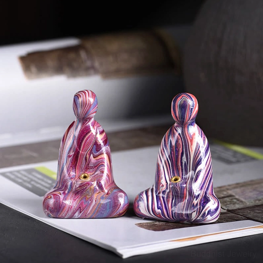 Pair of dark purple marbled Buddha incense holders with matching meditation design on printed backdrop
