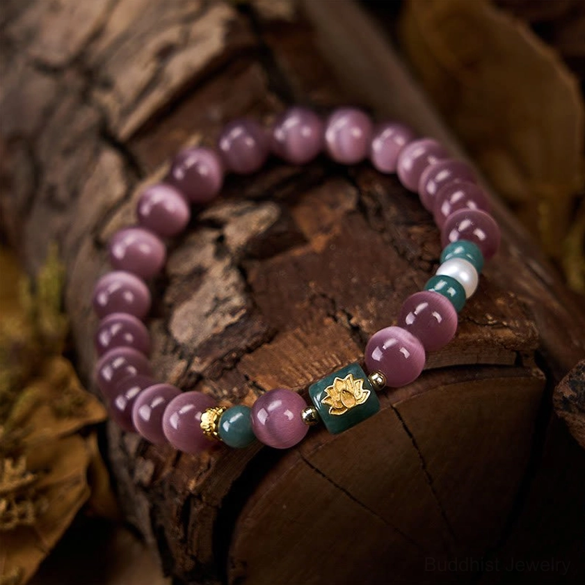 Purple cat's eye lotus bracelet side view on rustic tree bark background with warm natural lighting highlighting bead details